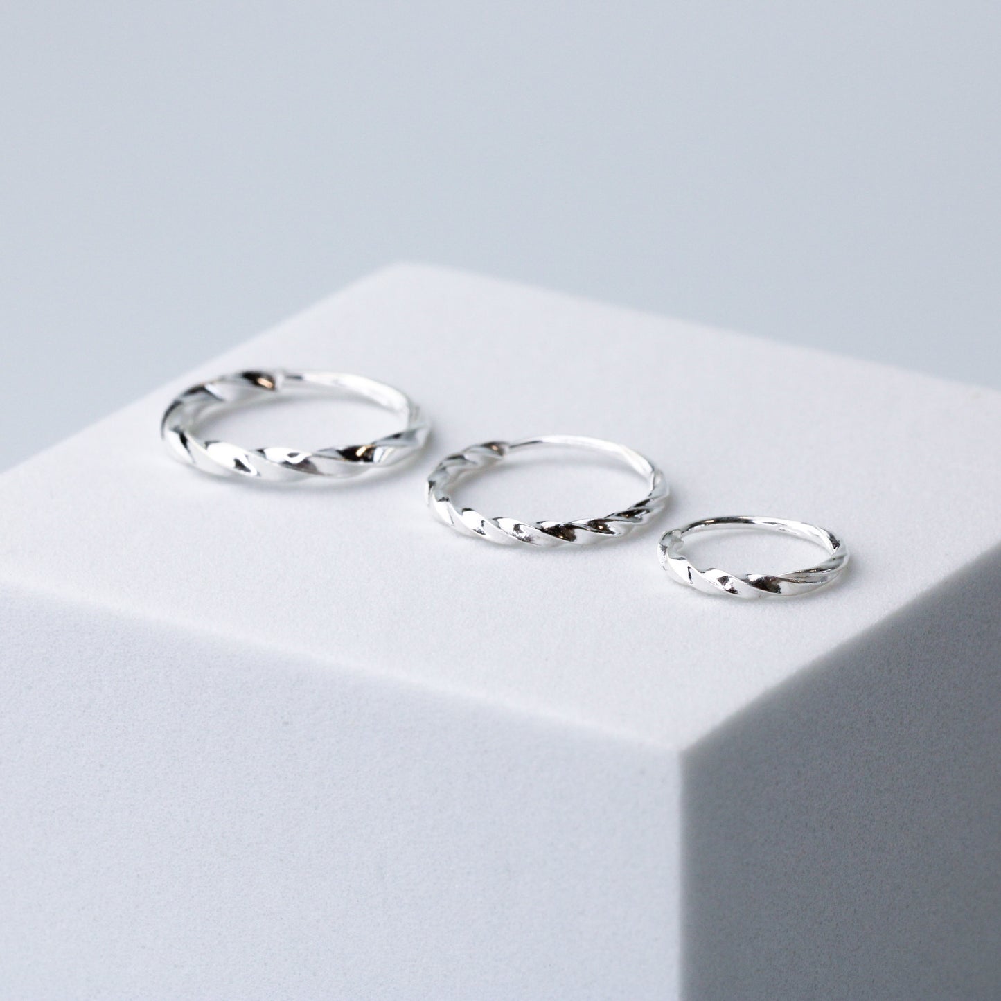 Twisted silver hoop earrings with a sleeper fastening, in three sizes