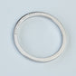 Silver ring with 'Dedicated to Korea' engraving on a light blue background