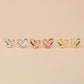 Three pairs of heart stud earrings, in silver, gold and rose gold colour