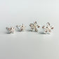 Two pairs of sterling silver flower stud earrings, in two different size options. They have a 3D moulded flower shape.