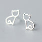 Silver stud earrings with a minimalist cat outline design